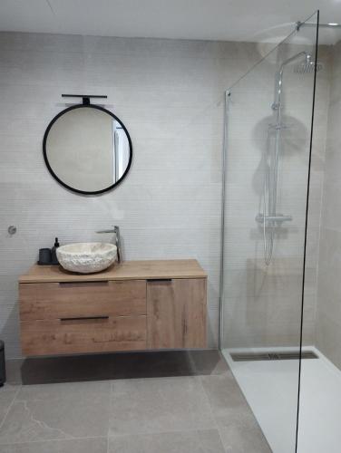 a bathroom with a mirror and a sink and a shower at Villa Costera B&B in Sant Antoni de Calonge