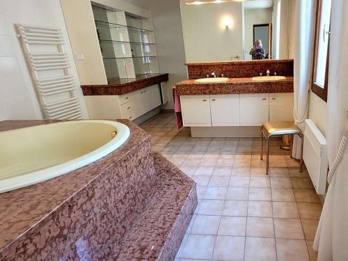 La grande salle de bains est pourvue de 2 lavabos et d'une baignoire. dans l'établissement Maison climatisée 5 pièces avec piscine et jardin, 7 couchages - Cavalaire-sur-Mer - FR-1-226B-86, à Cavalaire-sur-Mer