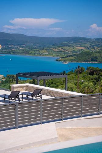 a view of a body of water with two benches at Dama Olga Villas in Lygia