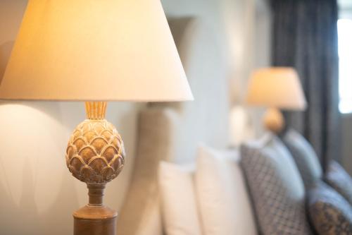 a lamp sitting on a table in a room at Manor House Hotel in Bishop Auckland