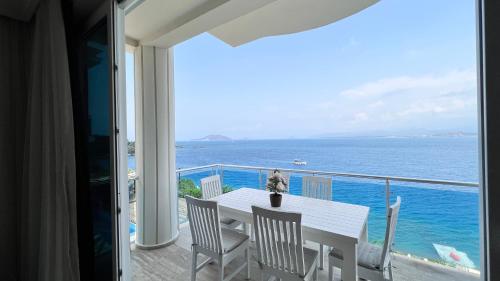 a white table and chairs on a balcony with the ocean at Sofia Ada in Fethiye