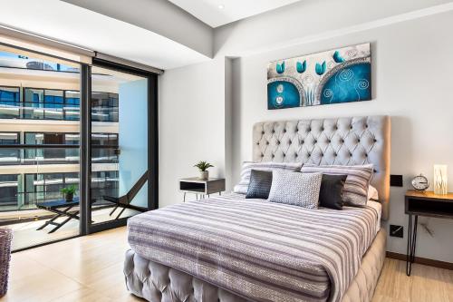 a bedroom with a large bed and a balcony at Tizate Residences #136 in Cruz de Huanacaxtle