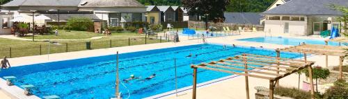a large swimming pool with people swimming in it at Hôtel Terminus in Luz-Saint-Sauveur