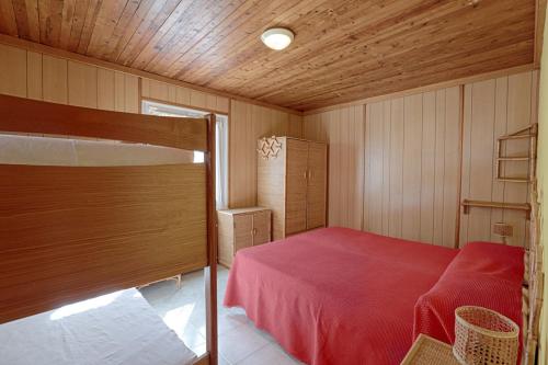 a bedroom with a bed in a wooden room at Villaggio Camping Valdeiva in Deiva Marina