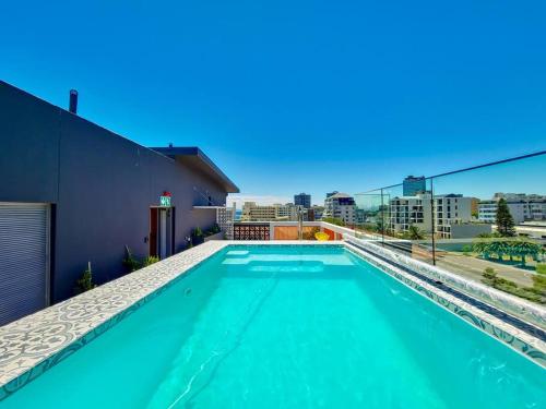 a swimming pool on top of a building at Secure Elegant Apartment Near Sea Point in Cape Town