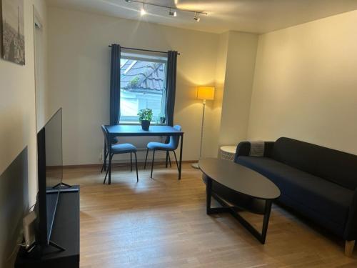 a living room with a couch and a table at Marken Apartments in Bergen