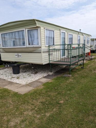 a green rv parked in a field at L&g caravan hire 6 BERTH CORAL BEACH LAURA FAMILYS ONLY AND LEAD PERSON MUST BE OVER 30 in Ingoldmells