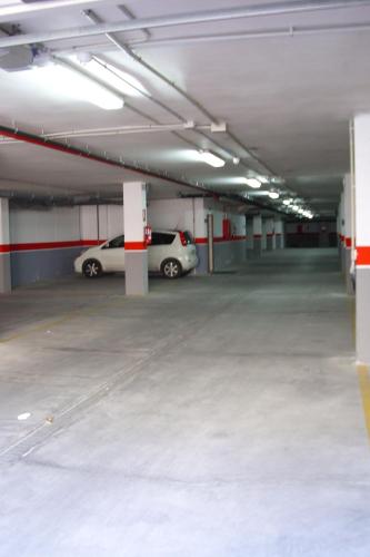 a parking garage with two cars parked in it at TCH Hotel in Lorquí