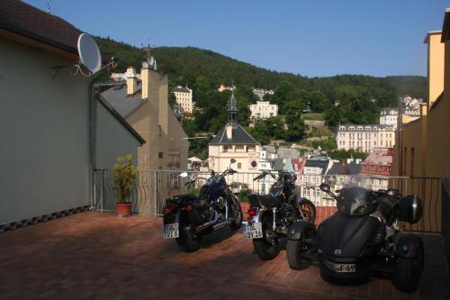 a group of motorcycles parked on a balcony at Chebsky dvur - Egerlander Hof in Karlovy Vary