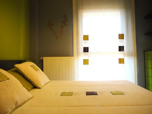 a bedroom with a bed with a large window at Jardines de Viana in Viana