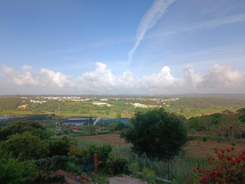 a view of a field with a rainbow in the sky at Casa Grande in Golpilheira