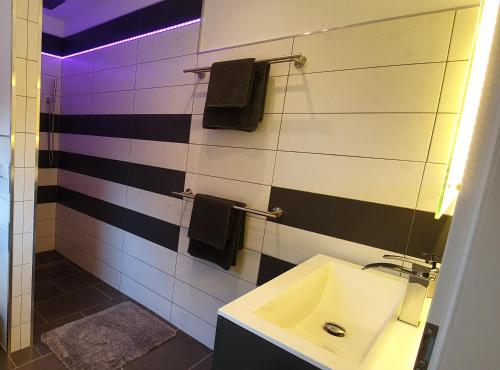 a bathroom with a sink and a mirror at Wohnung Fewo 4 