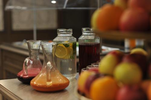 a table with two bottles of juice and some fruit at Crona SPA Karpaty in Skhidnitsa