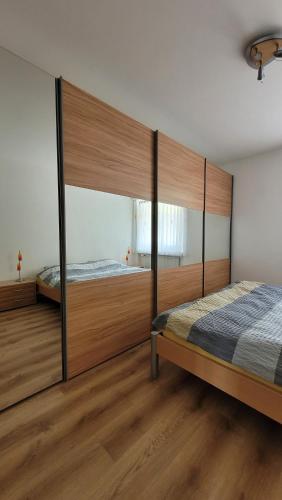 two beds in a bedroom with wooden flooring at Ferienwohnung an der Prodalp Talstation in Flumserberg