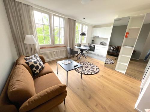 a living room with a couch and a table at RIVERSIDE - APARTMENTS BASEL deluxe in Basel