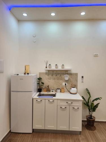 a kitchen with a white refrigerator and a sink at לנפוש בצפת in Safed