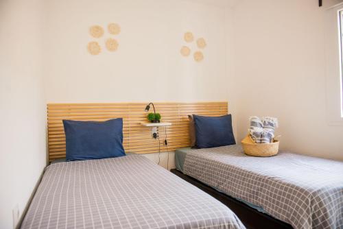 two beds sitting next to each other in a room at Casa de Almano - Torremolinos direct on beach in Torremolinos