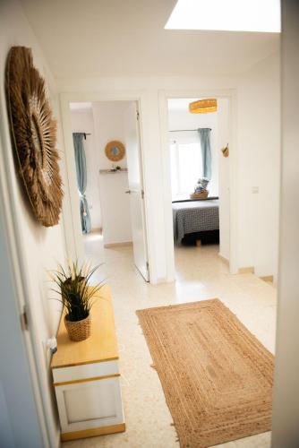 a hallway with a living room with a table and a kitchen at Casa de Almano - Torremolinos direct on beach in Torremolinos