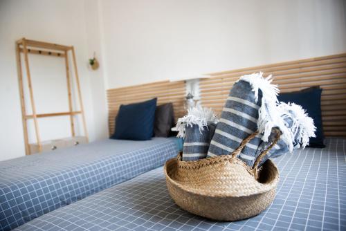 a room with a bed and a basket on the floor at Casa de Almano - Torremolinos direct on beach in Torremolinos