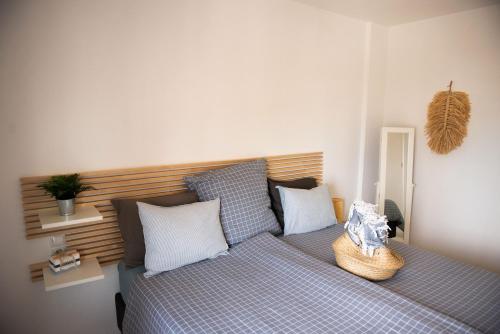 a bedroom with a bed with a basket on it at Casa de Almano - Torremolinos direct on beach in Torremolinos