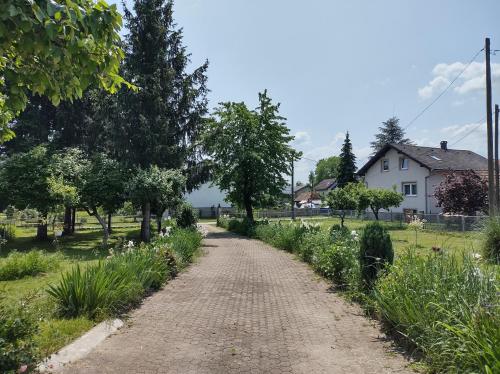 a dirt road in a field with trees and a house at Villa Drenje in Ključ Brdovečki