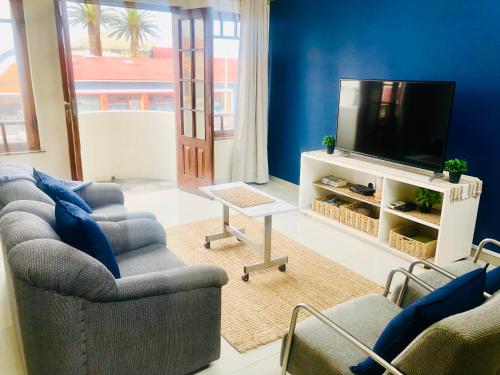 a living room with two couches and a flat screen tv at Bismarck 2 in Swakopmund