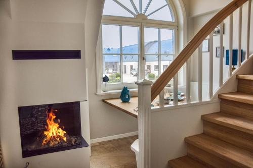 a fireplace in a living room with a window at Meeresblick-List in List