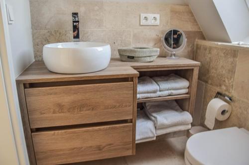 a bathroom with a sink and a toilet at Meeresblick-List in List