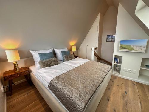 a bedroom with a large bed in a room at 2Land in Sicht in List