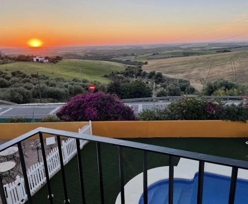 a sunset from the balcony of a house at Hotel Andalou in Montellano