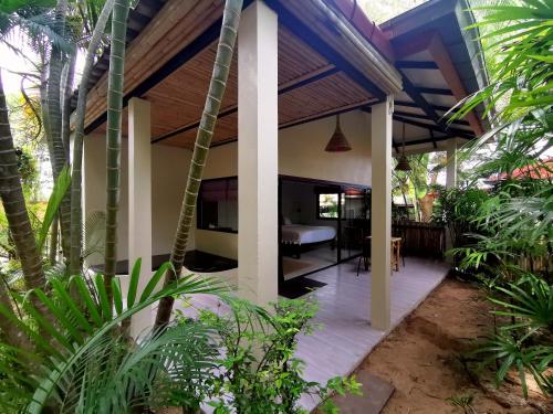 een overdekte veranda van een huis met een tafel bij Jade cottages in Koh Samui 