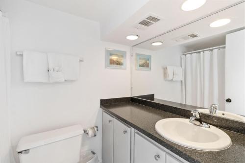 a white bathroom with a sink and a toilet at #231 F Madeira Beach Yacht Club in St. Pete Beach