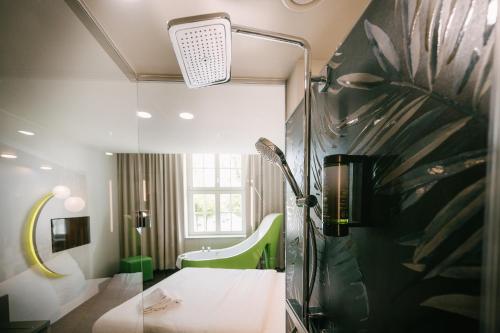 a bathroom with a shower with a glass wall at Travel24 Hotel Leipzig City in Leipzig