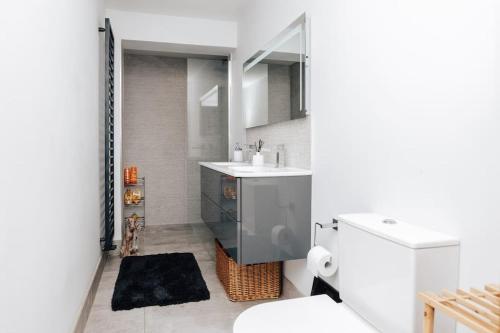 a white bathroom with a sink and a toilet at Henley Gardens in Henley on Thames