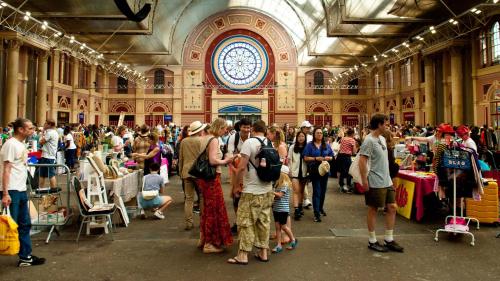 a large crowd of people in a large room with a clock at Muswell Hill B&B in London