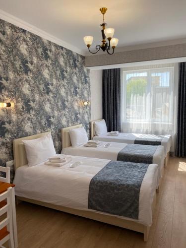 Postel nebo postele na pokoji v ubytování Hotel Sharl