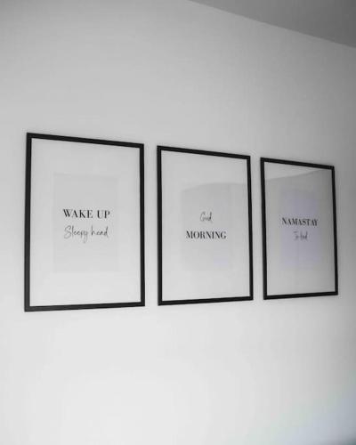 four picture frames on a wall with words on them at Comfortable Home In Bolton in Farnworth