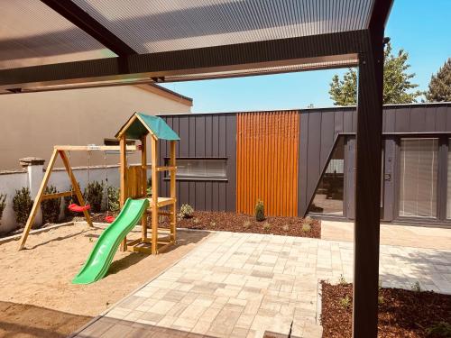 a playground with a slide in a backyard at Residence 7 in Štúrovo