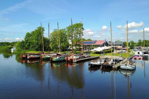 a group of boats docked at a marina on the water at Villa-am Wasser- Wellness-NationaalPark- in Earnewâld