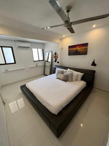 a bedroom with a large bed with a ceiling at Depa Kuxtal in Isla Mujeres