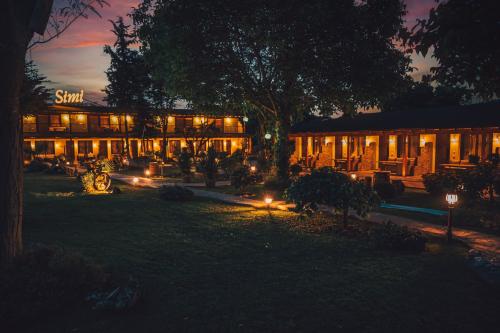 a building with lights in front of it at night at SIMI Luxury Suites in Plaka Litochorou