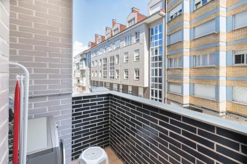 a balcony with a view of a building at Apartamento Santiago Lopez -Wifi-plaza de Garaje in Pravia