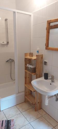a bathroom with a white sink and a shower at Dom na Mazurach Pilec in Pilec