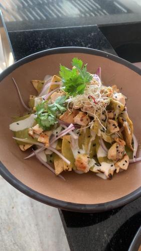 a bowl of food with a salad on a table at Singular Dream Beach Residences in Playa del Carmen