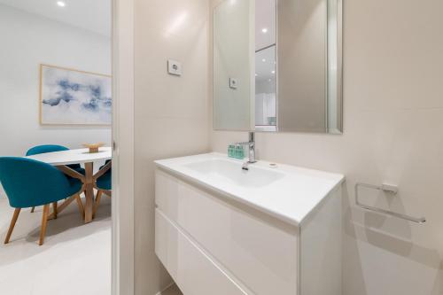 a white bathroom with a sink and a table at 2 bedrooms 2 bathrooms furnished - Delicias - modern- MintyStay in Madrid