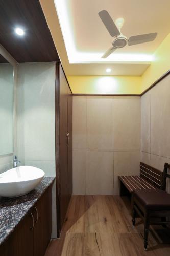 a bathroom with a sink and a ceiling fan at sri balaji grand hotel in Kumbakonam