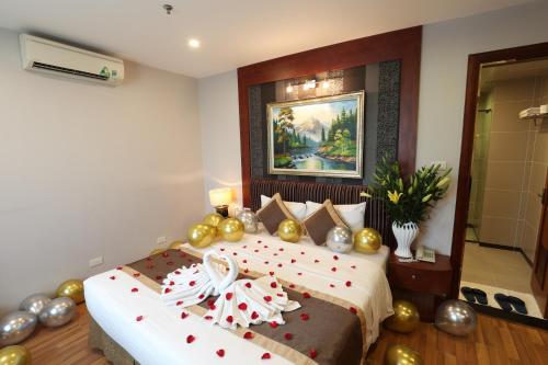 a bedroom with a bed with christmas decorations on it at Gallant Hotel in Hanoi