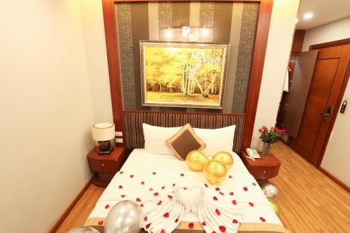 a bedroom with a bed with balloons on it at Gallant Hotel in Hanoi