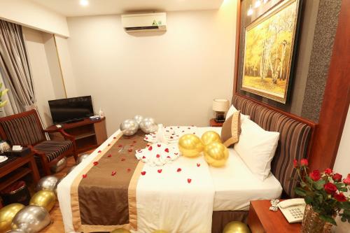 a hotel room with a bed with balloons on it at Gallant Hotel in Hanoi