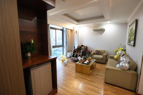 a living room with a couch and a table at Gallant Hotel in Hanoi
